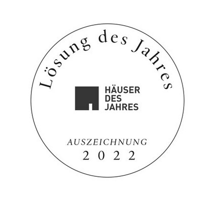 Zwart-witte medaille met tekst "Lösung des Jahres", "Häuser des Jahres" en jaartal "2022".