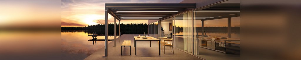 Moderne overkapping aan het water met zonsondergang op de achtergrond en een tafel met stoelen.